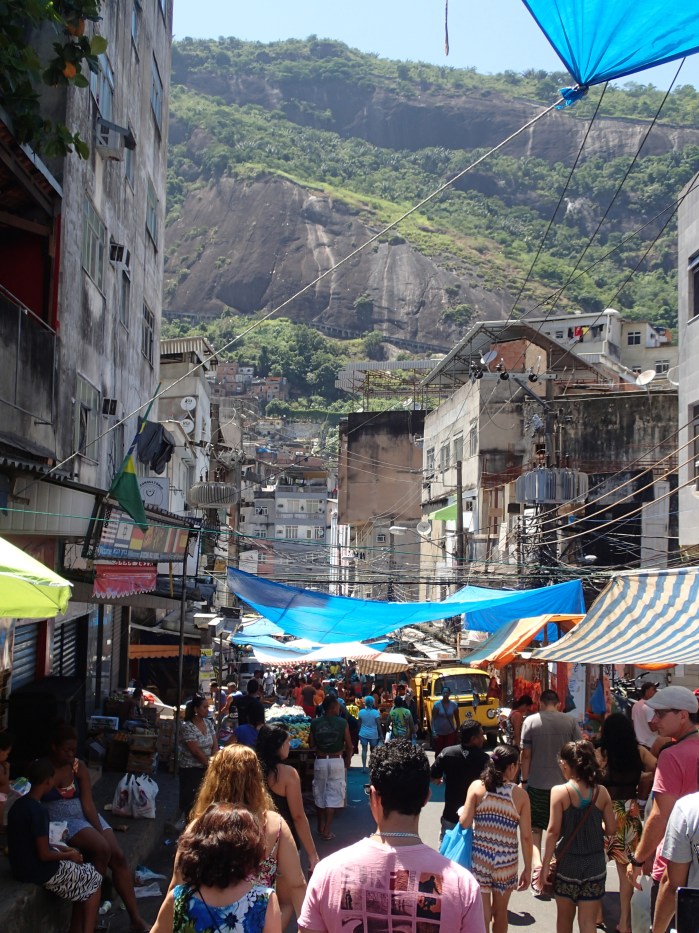 A vibrant city market attracting customers from all over, much like a farmer's market in the states.